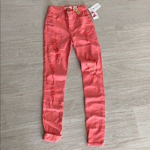 Stretchy distressed pink skinny jeans